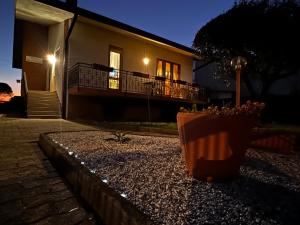 a plant in a pot sitting in front of a house at Villa Gianfranca - sentiti come a casa in Corno di Rosazzo
