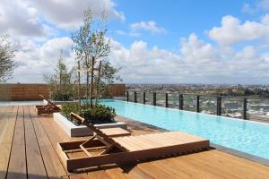 a swimming pool on the roof of a building at Luxurious Flemington with Stunning Racecourse View in Melbourne