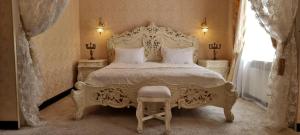 a bedroom with a large bed with a white bedspread at Oreanda Hotel in Odesa