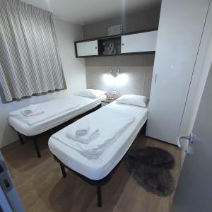 a hospital room with two beds and a window at Mobile House 4 you, Murter - Slanica in Murter