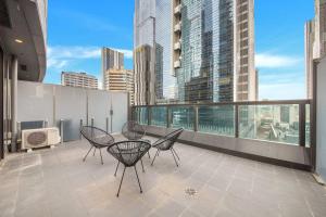 Un balcón con una mesa y sillas en un tejado. en A Cosmopolitan Hub in CBD Centre, en Melbourne