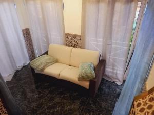 um sofá branco sentado num quarto com cortinas em ESTRELLA LOUNGE em Benalmádena
