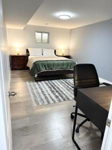 a bedroom with a bed and a desk and a chair at Cozy & Comfortable basement apartment in Mississauga