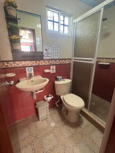 y baño con aseo y lavamanos. en Posada Faych House, en San Andrés