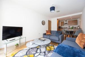 a living room with a couch and a table at Stylish Northern Quarter 2Bed, Free Parking, WI-FI, Sleeps 4, Central Location, Long term Disc in Manchester