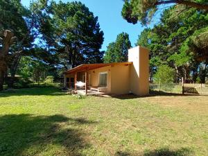 a small house in a field with trees at La Paloma Chapadmalal in Mar del Plata