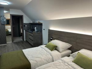 a bedroom with two beds and a bathroom at 4 Elements Resort Bled in Bohinjska Bela