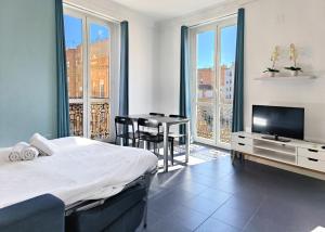 a bedroom with a bed and a table and a television at Flats Friends Torres Quart in Valencia
