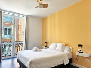 a bedroom with a large white bed with a window at Flats Friends Torres Quart in Valencia