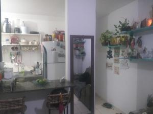 a kitchen with a sink and a refrigerator at RESIDENCIAL ALAMEDA JARDINS in Aracaju
