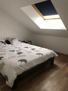 a bedroom with a bed with birds on it at Appart’ terrasse vue exceptionnelle 1er étage in Montbéliard