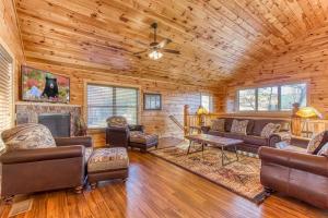 a living room with leather furniture and a fireplace at Blue Bear Lodge near Dollywood! 1 mile off PKWY Community Pool Hot tub Game Rm in Pigeon Forge