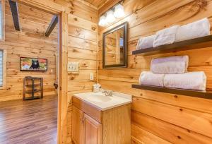 a bathroom with a sink in a wooden cabin at Blue Bear Lodge near Dollywood! 1 mile off PKWY Community Pool Hot tub Game Rm in Pigeon Forge