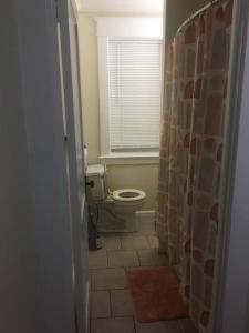 a bathroom with a toilet and a window at 2 bedroom suite in Schenectady +48 photos
