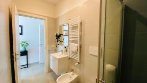a bathroom with a sink and a toilet and a mirror at Casa Cecilia in Rome +53 photos