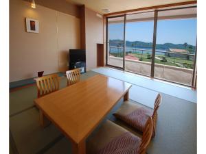 a dining room with a table and chairs and a large window at Hotel Alegria Gardens Amakusa - Vacation STAY 40452v in Amakusa +23 photos