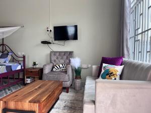 a living room with a couch and a coffee table at Dodoma Home Apartments in Dodoma