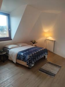 a bedroom with a king sized bed in a attic at Le Relais St Georges in Viroflay