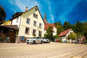 a white car parked in front of a building at RISA Hotel Village - Engel & Kreuz in Gaggenau