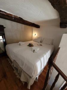 a bedroom with a white bed with flowers on it at La Barrade in Cagnes-sur-Mer