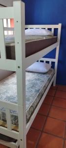 a couple of bunk beds in a room at Alas del Mar in Punta Del Diablo