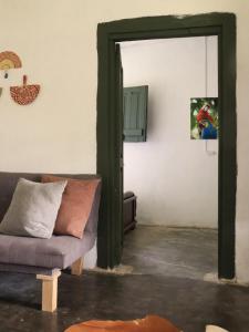 a living room with a couch and an open door at Allegra in Gómez Plata