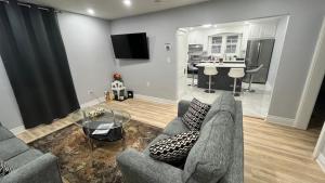 a living room with a couch and a table at Renovated Home - Walk to Falls & Tourist District in Niagara Falls