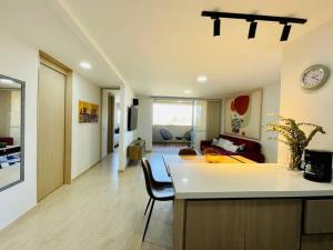 a kitchen and living room with a clock on the wall at Stunning view, near airport JMC, fast Wi-Fi in Marinilla