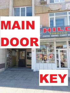 a main door of a store with signs in front at 3 Rooms Apartment, Center, 1st Floor, AUBG, Free Parking, PC i5 SSD, 3 LED TVs 200 Channels, WiFi, Terrace, Easy-Late Check-in, Stay Before Greece in Blagoevgrad