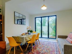 a dining room with a table and yellow chairs at 2 Bed in Broadstairs 89889 in Broadstairs