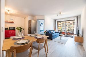 a dining room and living room with a table and chairs at Appartement cosy au centre ville de Menton in Menton