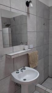 a bathroom with a sink and a mirror at Cabaña Yerba Buena in Carpintería