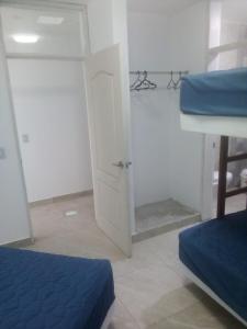 Zimmer mit 2 Betten und einer Tür in der Unterkunft CONDOMINIO MORAVIA 2 33 in Bujama Baja