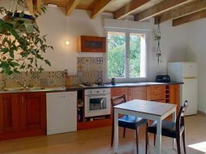 una cucina con un tavolo, una stufa e un lavandino di Gîte à la ferme a Questembert
