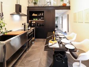 a kitchen with a long table with white chairs at The Pump House Forge in Doncaster