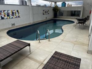 a swimming pool on top of a building at Flat Hotel Mercure - 4 Estrelas Moema SP in Sao Paulo