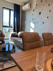 a living room with a table and a couch at BW Libera luxury apartment in Belgrade