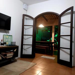 a living room with two glass doors and a aquarium at VILLA PRAIA GRANDE in Matinhos