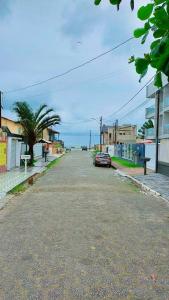 an empty street with a car parked on the side at VILLA PRAIA GRANDE in Matinhos