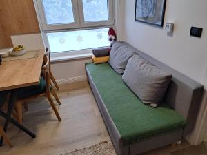 a living room with a couch and a table at Apartman Lenka Villa Mont Jahorina in Jahorina
