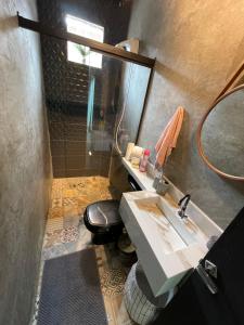 a bathroom with a sink and a mirror and a toilet at Apto Moderno - Centro in Macapá +26 photos