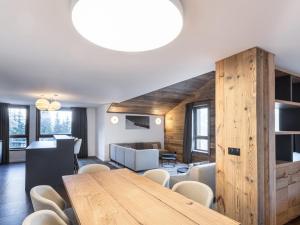 a dining room with a wooden table and chairs at Appartement Courchevel 1650, 3 pièces, 6 personnes - FR-1-618-30 in Courchevel