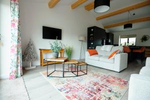 Una sala de estar con un sofá blanco y una mesa. en Ingleborough Lodge, en Settle