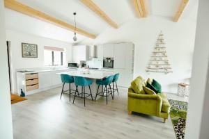 a kitchen with a table and chairs and a christmas tree at Whernside Lodge in Settle +15 photos