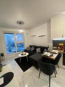 a living room with a couch and a table at ST55 Apartament in Rzeszów