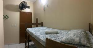Dormitorio pequeño con cama y mesa en CASA MEUS AMIGOS KITESURF in the center of Cumbuco, en Cumbuco