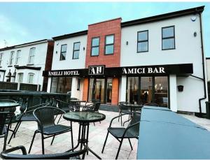 a group of tables and chairs in front of a music bar at Anelli Hotel in Southport