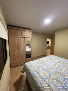 a bedroom with a bed and a dresser at Lomeli’s Home, Majahual Beach in La Libertad