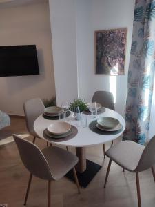 a dining room with a white table and chairs at La Noguera Rural Suite in Güéjar-Sierra