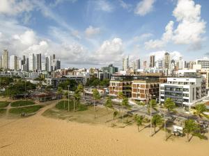 a view of a city with buildings and palm trees at BA'RA Hotel in João Pessoa